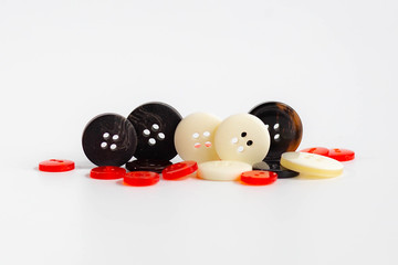 small sewing buttons made of plastic on isolated background 