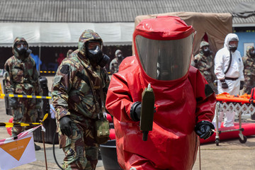 they are in protective gear cleaning up after chemical or radiation accident and radiation sefety.