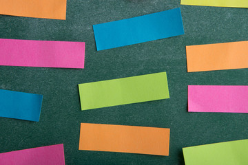 Colorful sticky notes on the blank blackboard