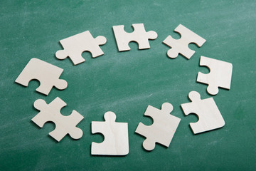 Obraz premium Creative solution for idea - business concept, jigsaw puzzle on the blackboard