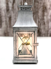 Burning vintage lamp on a gray-white background. Modern lamp made under the vintage style.