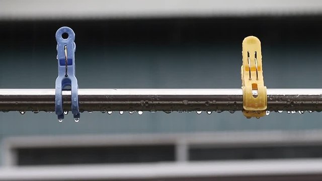 Clothespins and laundry pole get wet in the rain at rany day at outsider in Japan