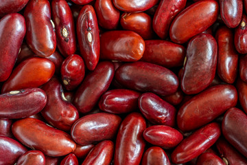 Closeup of raw red kidney beans background, top view, details. Food and drink concept
