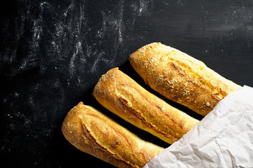Three baguettes in the package on a black background