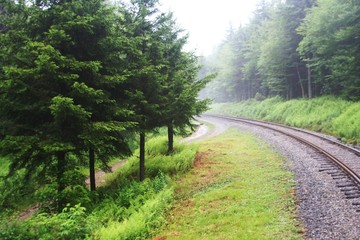 Fototapeta na wymiar Railroad through a foggy mountain