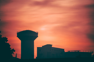 Silhouette of water tower during sunset