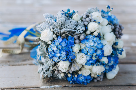 Wedding beauty blue wedding flowers on the sea on the old wooden bridge