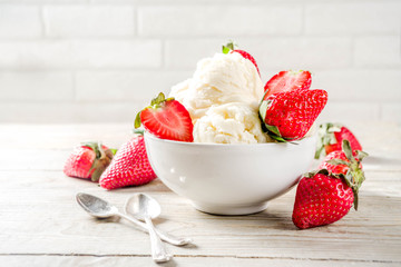 Homemade strawberry vanilla ice cream with fresh strawberries. Sweet berry summer dessert. Wooden background copy space