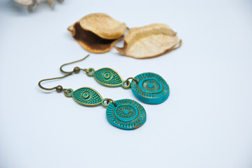 Boho chic earrings turquoise and bronze. White background with jewelry. Fashion handmade  jewellery.