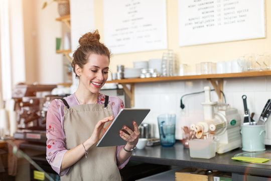 Young woman using digital tablet in coffee shop