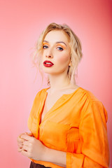 An image of a beautiful young blonde girl with an original hairstyle and bright professional makeup. On white isolated background.