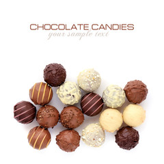 Delicious chocolate candies isolated on white background. Top view. Space for your text