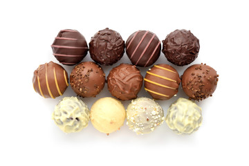 Top view of various chocolate pralines isolated on white background