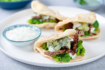 Mini flat breads with crispy lamb, mashed peas, cucumber, mint and yogurt sauce
