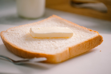 Sliced bread bake and butter on wooden tray. Simple breakfast
