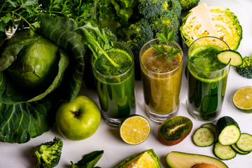 Vegan food and drinks with spinach, kiwi and cucumber on the white wooden background. Raw drinks and foods.