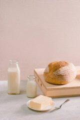 Bread bake and butter on wooden cutting board. Simple breakfast