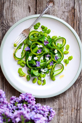 Salad with asparagus ribbons, broad beans and lilac