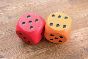 two large dice for playing in a casino on a wooden table, macro photography