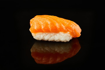 Classical sushi with salmon on black background for menu. Japanese food