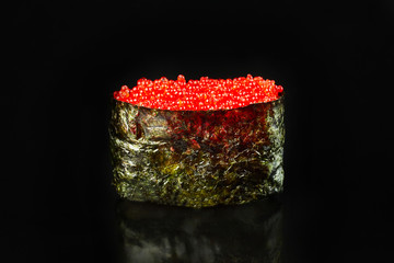 Sushi with red caviar on black background for menu. Japanese food