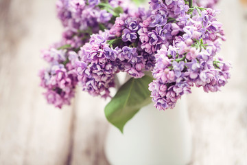 Lilac flowers in white vase