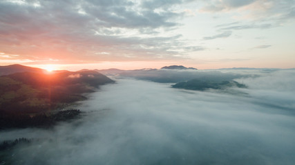 Aerial view. of sunset or sunrise  and fog.in the valley  between mountains .
