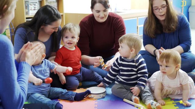 Mothers And Babies Playing Instruments And Singing At Music Group 