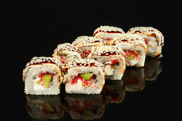 Philadelphia roll sushi with smoked eel, avocado, cream cheese on black background for menu. Japanese food