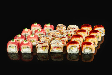 Various kinds of tasty sushi roll  isolated on black background for menu. Japanese food