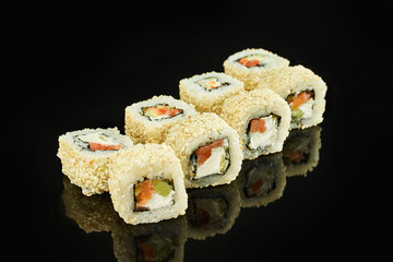 California roll sushi with salmon, avocado, cream cheese on black background for menu. Japanese food