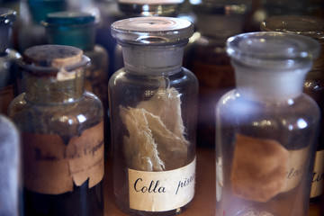 Old bottles with herbs and medicines in the pharmacy
