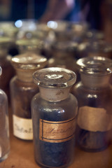 Old bottles with herbs and medicines in the pharmacy