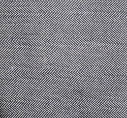 Herringbone fabric, texture background. Black and white tweed pattern, weaving, textile material. 