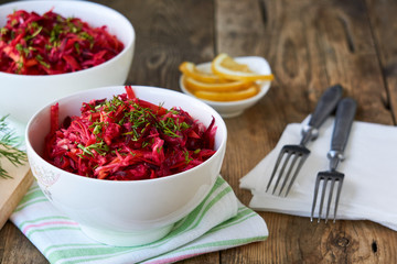 Vegetable salad with beets, cabbage and carrots in a white bowl    