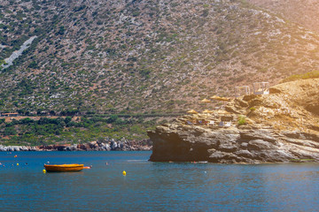 Sun beds on a rock by the sea