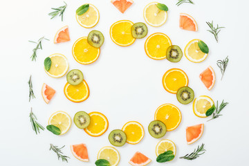 Flat lay with cut fruits and rosemary on white surface