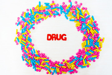 The word letters DRUGS and various medication and pills