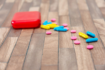 Health concept colorful medication and pills spilling out of a toppled bottle