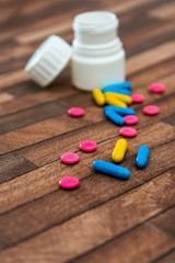 Health concept colorful medication and pills spilling out of a toppled bottle