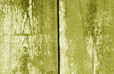 Old grungy wooden planks background in yellow tone.