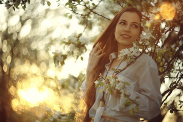 Spring portrait in apple blossoms young adult beautiful girl