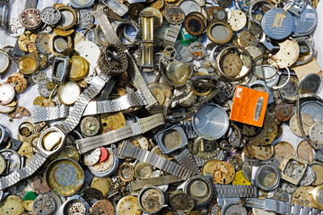 Old and vintage watch and clock parts in a flea market