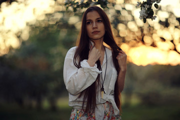 Summer sunny park portrait of a beautiful young woman