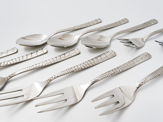 cutlery forks and spoons on a white background
