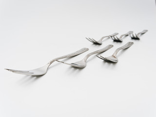 cutlery forks and spoons on a white background