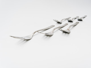 cutlery forks and spoons on a white background