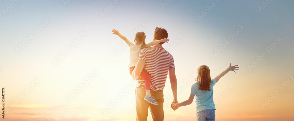 Wall mural happy family at sunset.