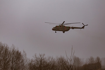 Fototapeta na wymiar Mi-8 helicopters in the cloudy sky