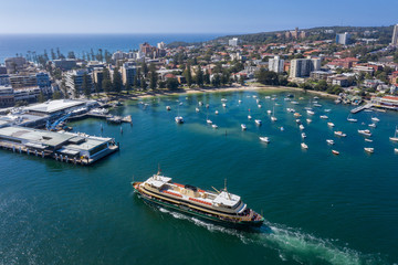 Fototapeta na wymiar Aerial view of the Circular Quay ferry approaching Manly Wharf and harbour in Sydney, Australia